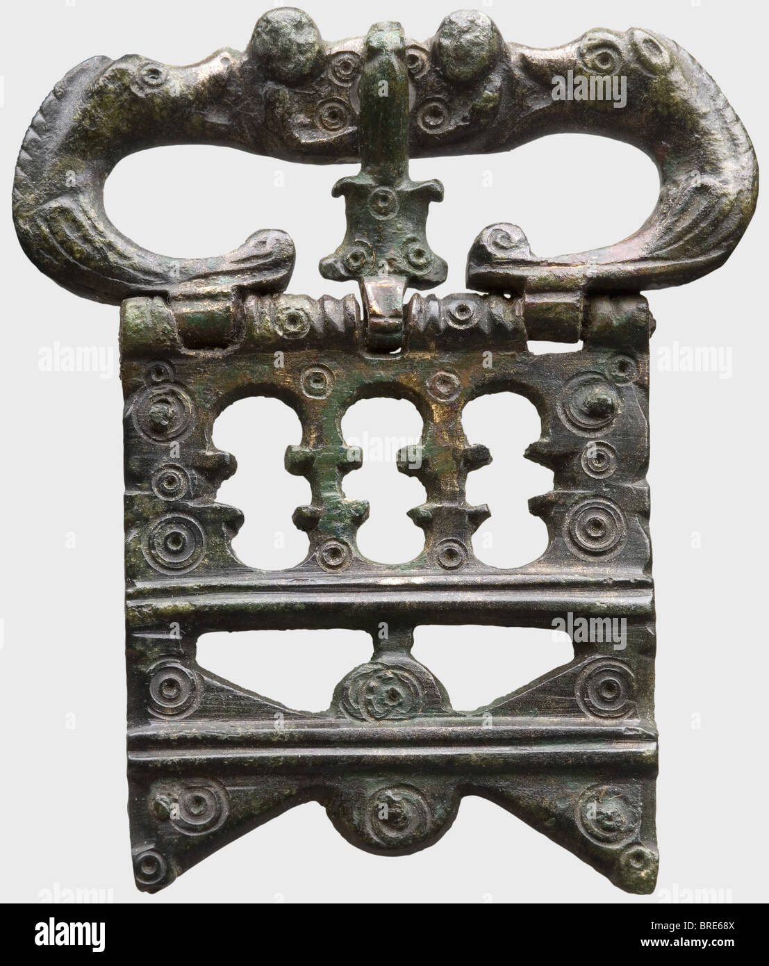 A Late Roman military belt, 4th/5th century A.D. Bronze openwork, lavishly contoured belt buckle. Six identical propeller-shaped mountings, formerly riveted to the leather. A spear-shaped tongue piece for the end of the belt. Rich point and notch decoration. Width of the belt buckle 7.8 cm. Height of the fittings 4.7 cm. Metal preserved with reddish brown to green patina. Mounted on acrylic. Axel Guttmann Collection (no inventory number). Beautiful, and very well-preserved military accouterment for the late Roman Army. historic, historical, ancient world, ancie, Stock Photo