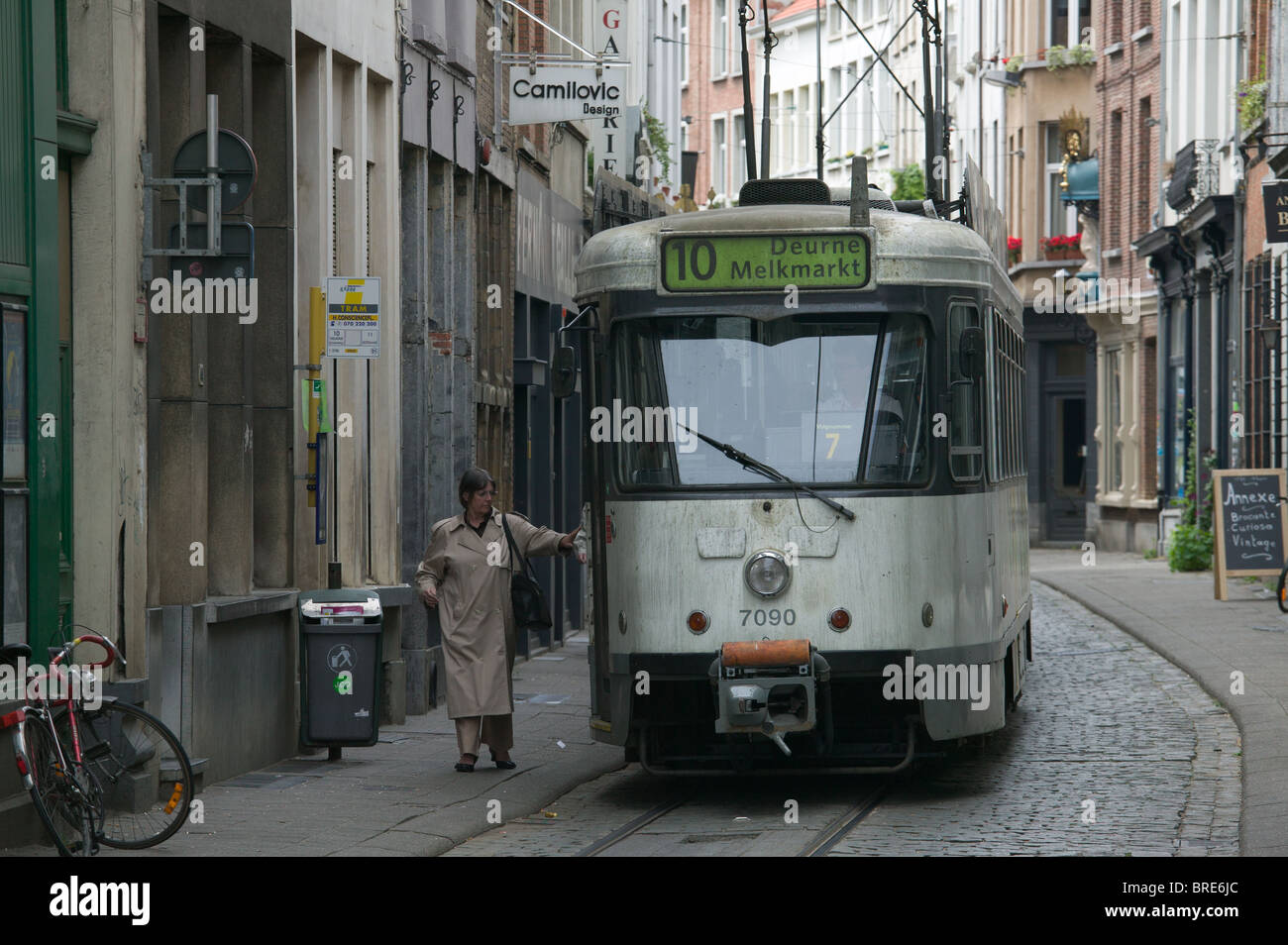 A woman boards tram line 10 on Wolstraat in Antwerp, Belgium Stock Photo