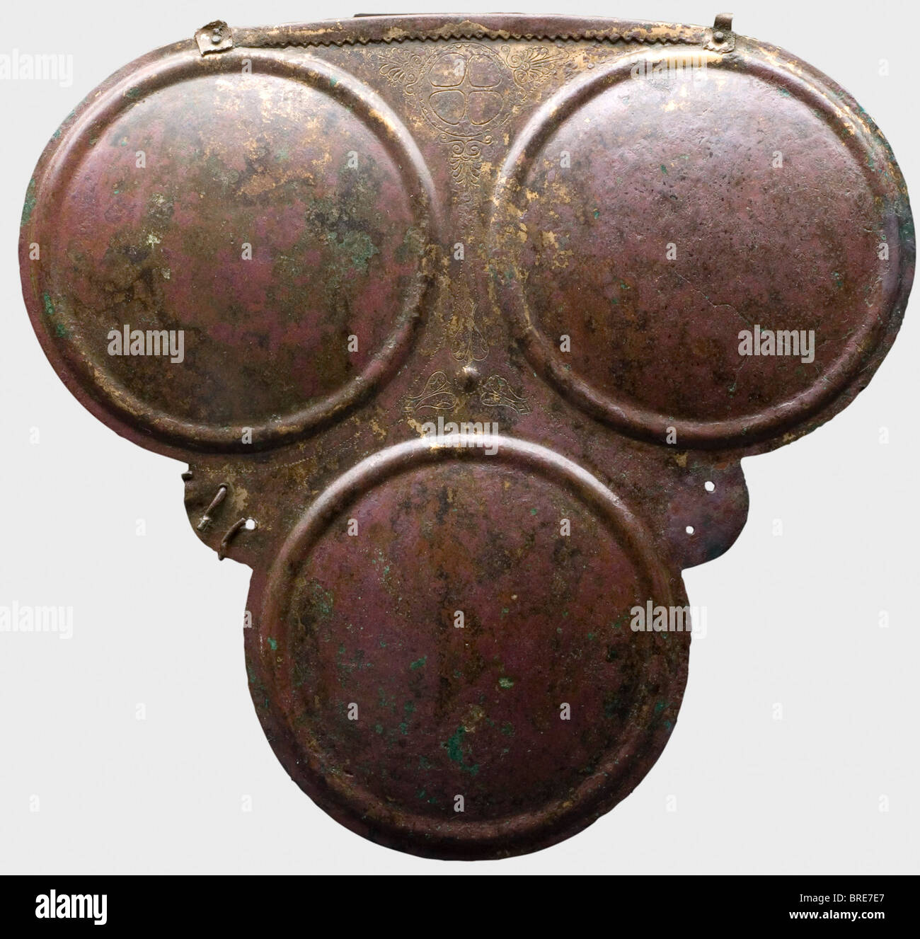 A Samnite triple disc breastplate, 4th century B.C. A bronze breastplate with three large discs, and fine decorative lines of dots and a four-spoke wheel ornament amid palmettes. A small umbo within leaf decoration in the centre of the armour plate. The upper rim is serrated and folded outward, with an attachment (fragments preserved) riveted at the each end for the rings of the shoulder harness. A pair of small holes in the lateral flaps and flaring remnants of the bronze fastenings for the side pieces. Height 24.5 cm. Width 26.2 cm. Wei historic, historical, , Stock Photo