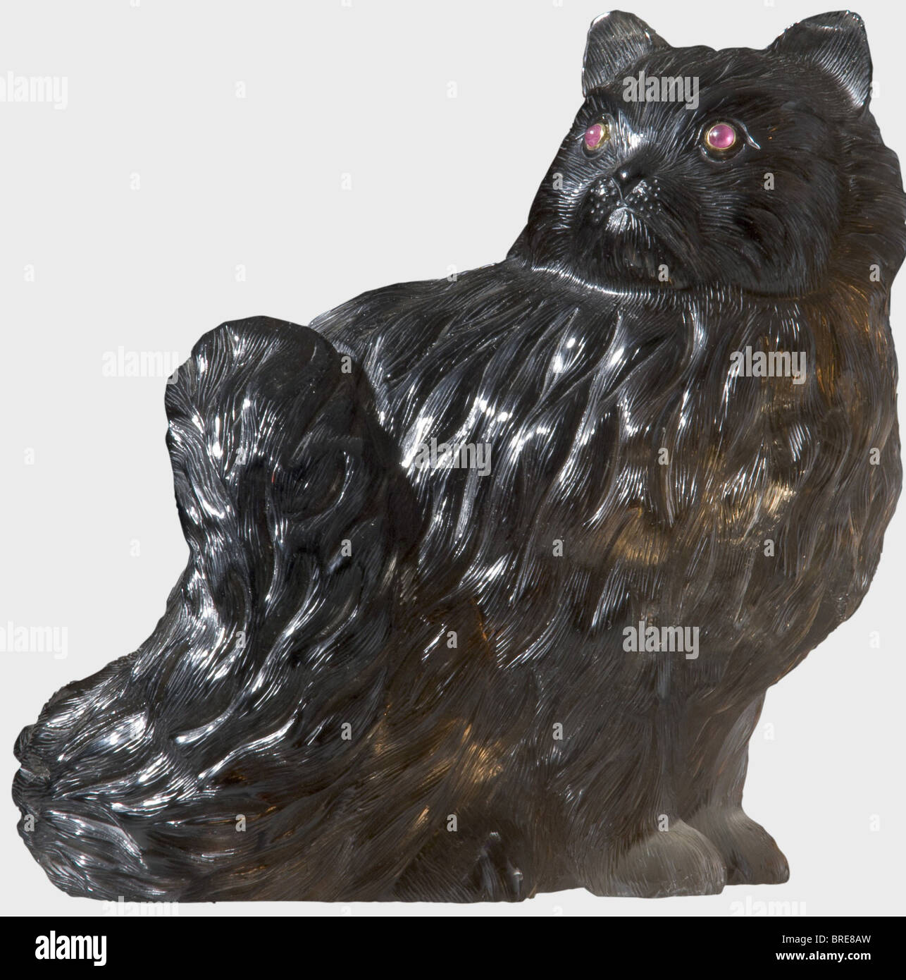 A figure of a Persian cat, attributed to Karl Fabergé, circa 1910 Made of smoky quartz, with elaborately and finely carved coat. Two ruby eyes set in gold. Height 16.6 cm. According to the consignor, this lot formerly belonged to a Russian expatriate living in England. historic, historical, 1910s, 20th century, sculpture, sculptures, statuette, figurine, figurines, statuettes, fine arts, art, object, objects, stills, clipping, clippings, cut out, cut-out, cut-outs, Stock Photo