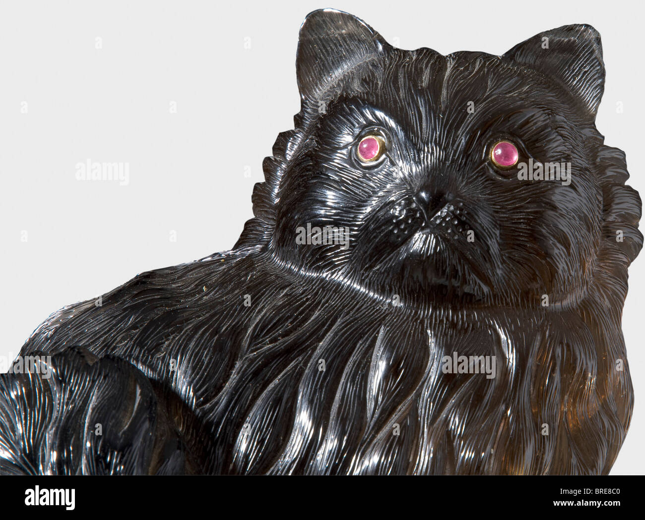 A figure of a Persian cat, attributed to Karl Fabergé, circa 1910 Made of smoky quartz, with elaborately and finely carved coat. Two ruby eyes set in gold. Height 16.6 cm. According to the consignor, this lot formerly belonged to a Russian expatriate living in England. historic, historical, 1910s, 20th century, object, objects, stills, clipping, clippings, cut out, cut-out, cut-outs, sculpture, sculptures, statuette, figurine, figurines, statuettes, fine arts, art, Stock Photo