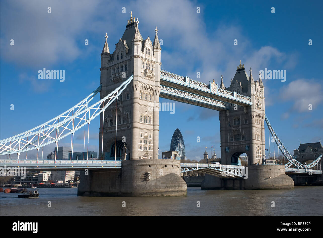 A view of Tower Bridge spanning the river Thames, with the gherkin in the background in London, England, UK. Stock Photo