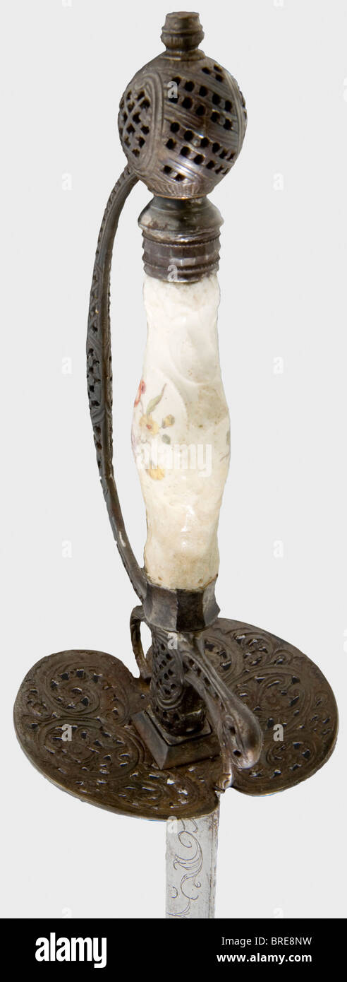 A French small-sword with a porcelain grip, circa 1780 A Colichemarde blade engraved with scroll work and with an illegible motto on the reverse side. Openwork, chiselled iron hilt with a porcelain grip. Blade somewhat stained, grip repaired, one grip ferrule replaced. Length 96 cm. historic, historical, 18th century, dress sword, swords, thrusting, thrustings, smallsword, epee de cour, weapon, arms, weapons, arms, military, militaria, object, objects, stills, clipping, clippings, cut out, cut-out, cut-outs, Stock Photo