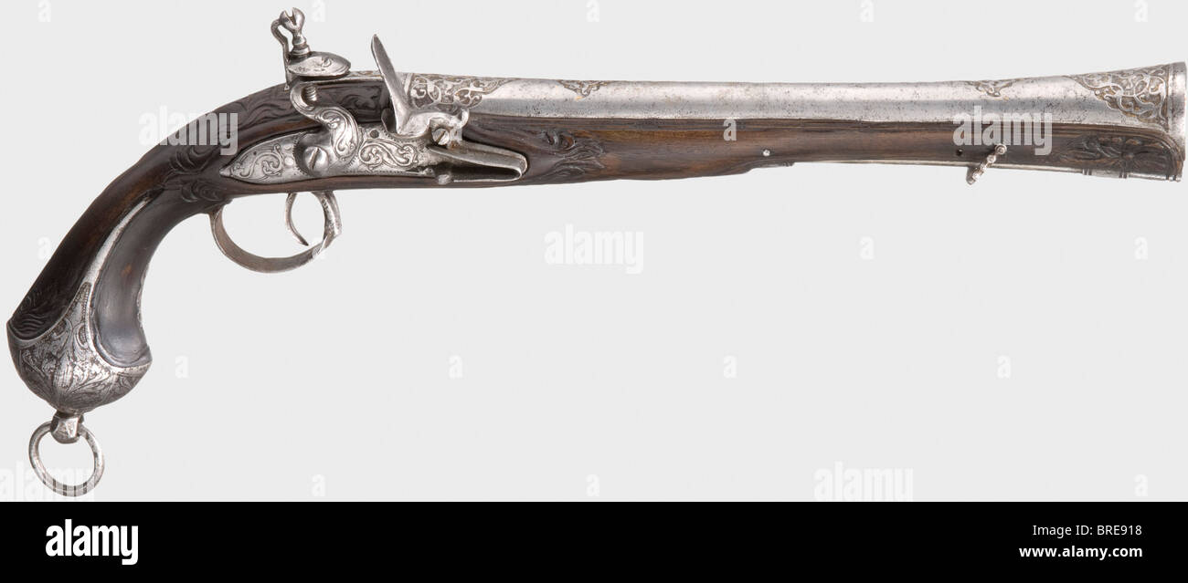 An Ottoman blunderbuss pistol, 18th century Round barrel, widening into a trumpet-shape at the muzzle with remnants of chiselled and gilt ornamental designs on the muzzle and breech. Iron flintlock, cut with intertwined monsters. Carved dark walnut stock with chiselled (somewhat pitted) furniture. Iron pommel ring and short iron ramrod. Length 47 cm. historic, historical, 18th century, Ottoman Empire, handgun, handheld, firearm, fire arm, gun, fire arms, firearms, guns, weapon, arms, weapons, arms, pistols, object, objects, stills, clipping, clippings, cut out,, Stock Photo