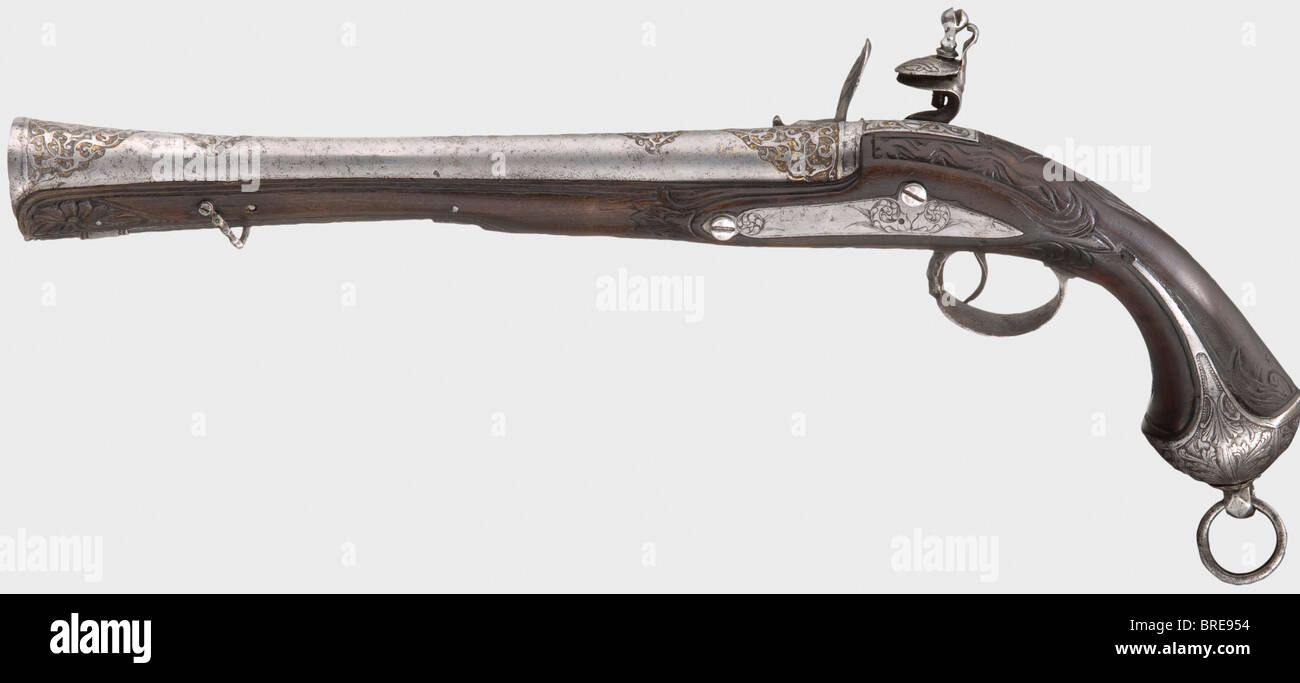 An Ottoman blunderbuss pistol, 18th century Round barrel, widening into a trumpet-shape at the muzzle with remnants of chiselled and gilt ornamental designs on the muzzle and breech. Iron flintlock, cut with intertwined monsters. Carved dark walnut stock with chiselled (somewhat pitted) furniture. Iron pommel ring and short iron ramrod. Length 47 cm. historic, historical, 18th century, Ottoman Empire, handgun, handheld, firearm, fire arm, gun, fire arms, firearms, guns, weapon, arms, weapons, arms, pistols, object, objects, stills, clipping, clippings, cut out,, Stock Photo