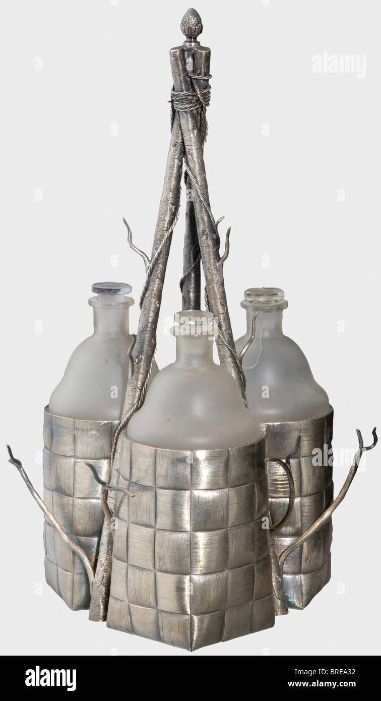 A silver trompe l'oeil vodka service, St. Petersburg master 'VI', circa 1880 Silver in the shape of three baskets on three birch branches with twigs as holders for the missing vodka glasses. Three original, frosted glass flasks, (one cracked) with stoppers. Several Cyrillic master's marks 'VI' (Vassili Ivanov 1892 -98?) and the St. Petersburg hallmark for '84' zolotniki. Height 40.5 cm. Weight (without flasks) 1400 g. Outstanding condition. historic, historical, 19th century, object, objects, stills, clipping, clippings, cut out, cut-out, cut-outs, fine arts, a, Stock Photo