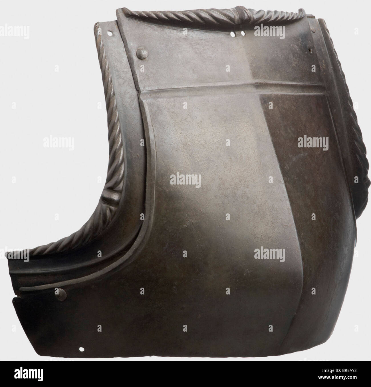 A German breastplate for a suit of armour, circa 1500 Ridged, blackened breastplate with a prominent central projection and sliding gussets, the edges heavily flanged and lavishly roped. Of the two shoulder clasps and rivets at the gussets in each case one preserved. Height 27 cm. historic, historical, 16th century, defensive arms, weapons, arms, weapon, arm, fighting device, object, objects, stills, clipping, clippings, cut out, cut-out, cut-outs, utensil, piece of equipment, utensils, plating, armour-plating, armour, armor, reactive armour, armour suit, armor, Stock Photo