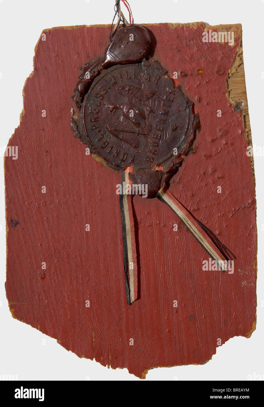 Manfred Freiherr von Richthofen (1892 - 1918), a fragment of the body of an Albatros D V Three-layered plywood, size ca. 72 x 102 mm, painted red on one side, clear coat on the reverse. Attached with sealing wax a typewritten label bearing the inscription (transl.) 'the piece of plywood at hand comes from the aircraft, which landed on 11.6.17 on Crefeld-Bockum airfield. It was flown by combat pilot Cavalry Captain Freiherr von Richthofen and was damaged during the landing manoeuvre. The verification and authenticity is confirmed herewith: 12.6.1917.' With a sta, Stock Photo