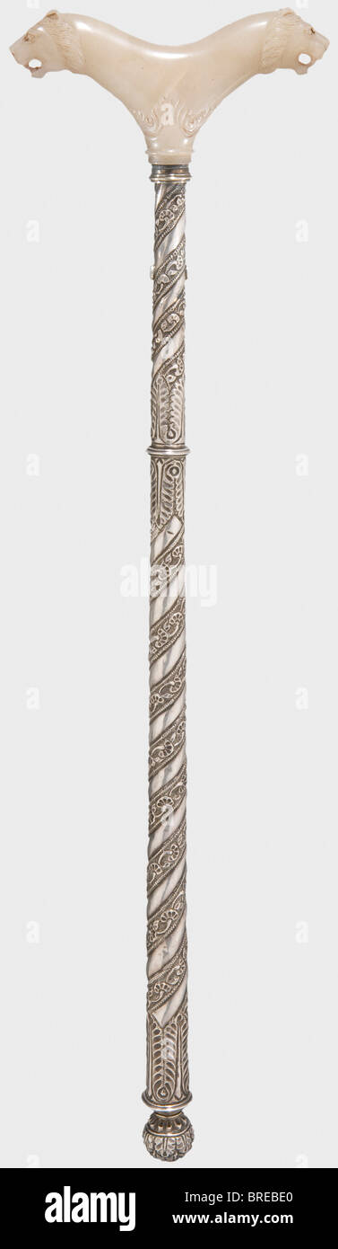 An Indian crutch with a cut jade handle, 17th/18th century One-piece, light grey jade handle with two sculpted lion heads on the sides on a base with cut floral designs. The (somewhat later) tapering silver shaft is surrounded with a spiral pattern of embossed floral decoration and has a spherical pommel. Length 61 cm historic, historical, 18th century, object, objects, stills, clipping, clippings, cut out, cut-out, cut-outs, fine arts, art, artful, Stock Photo
