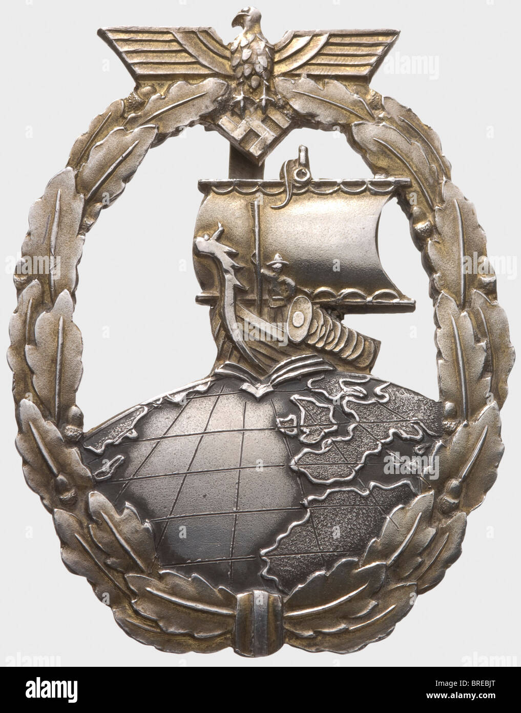 A Auxiliary Cruisers War Badge in sterling silver, for the crew of auxiliary cruiser 'Thor' One-piece silver version with gilt wreath and Viking ship, the globe with incised latitude and longitude lines. Reverse wide attachment pin, punched 'Sterling' as well as weakly inscribed wearer's name 'Georg König(?)'. Weight 47.5 g. On her second cruise (12 January - 30 November 1942) 'Thor' sank 57,032 GRT of enemy shipping and made port at Yokohama to take on fuel and supplies. On this occasion the awards, for want of standard service issue badges, were provided on c, Stock Photo