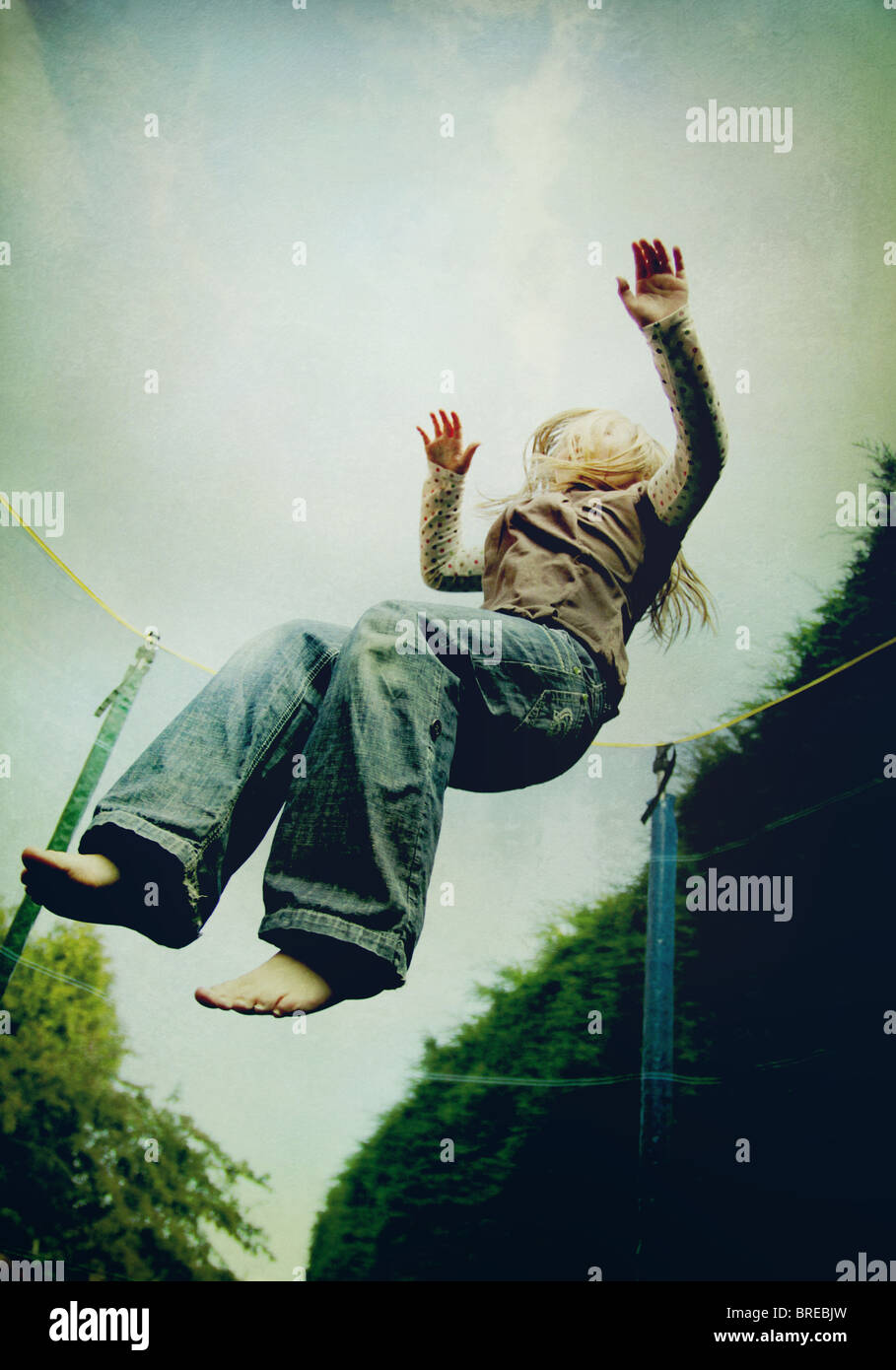 girl jumping on a trampoline Stock Photo