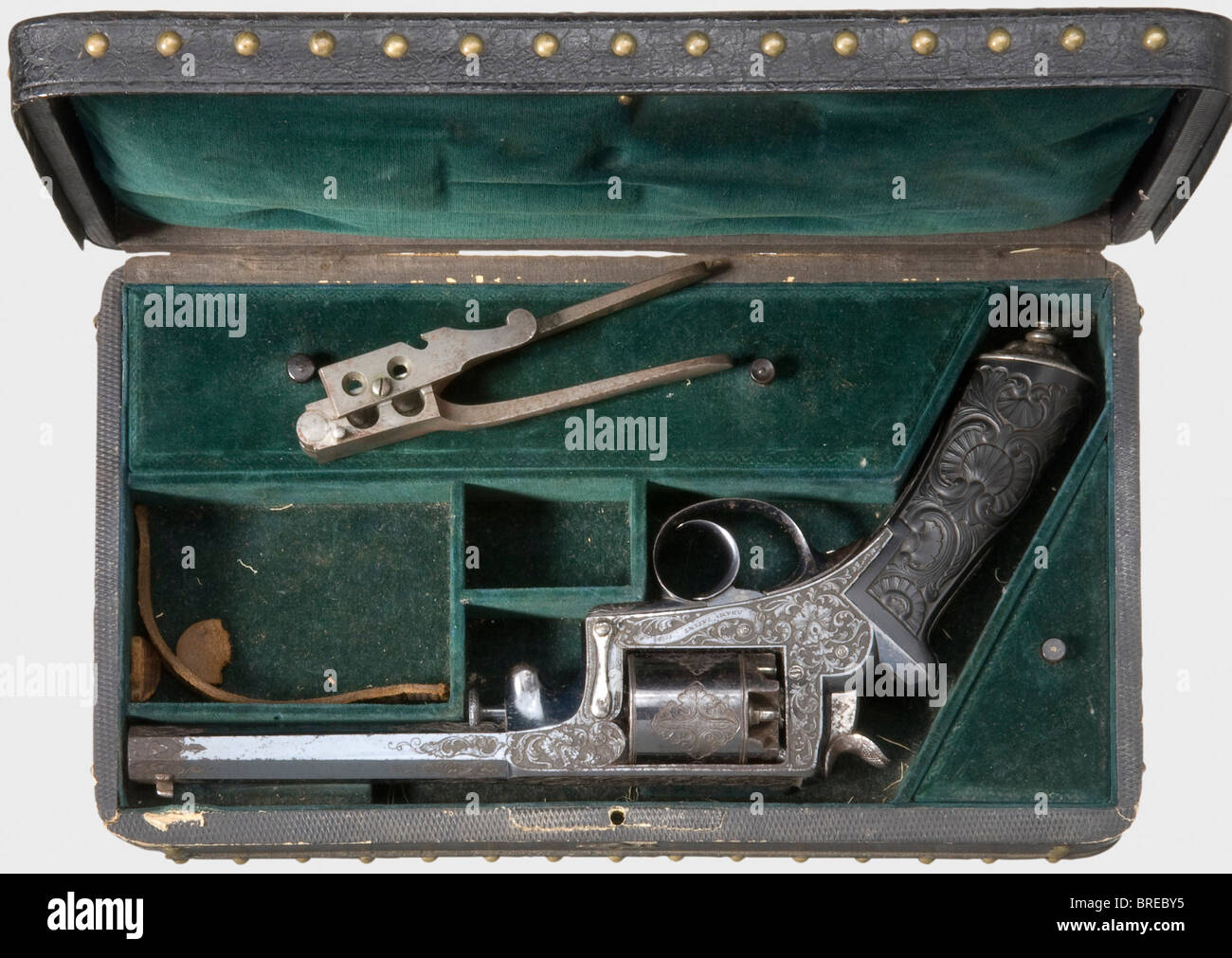 A fine cased Adams percussion revolver, Liège, circa 1855. Double action, cal..455, no. 11068. Octagonal barrel with a side-mounted loading rod. The frame is inscribed 'Adams Patent' and 'Adams Patent 1851' on the side. Ebony grip with finely carved rocaille decoration. Beautifully cut iron pommel cap with a small disk pommel. Metal parts display deeply chiselled, high quality, vine decoration. Original high gloss bluing, more than 90 % preserved, with a slight rust film in places. Length 31.5 cm. In the matching, cloth lined case with decorative brass nails. A, Stock Photo