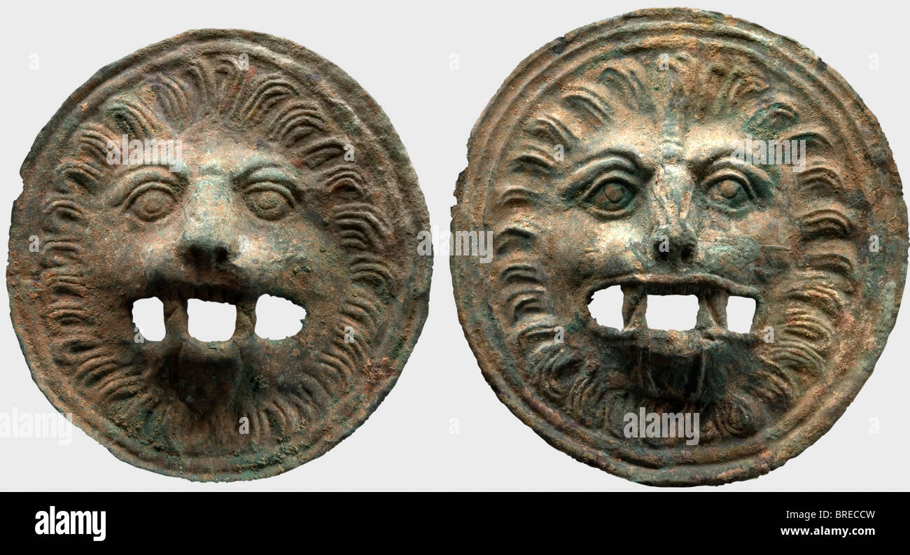 A pair of Roman lion head appliqués, 2nd/3rd century A.D. Slightly different round appliqués of sheet bronze with a heavy green patina. Finely embossed lion heads in relief with open work jaws. Cleaned excavation find. Diameters 18 and 19 cm. historic, historical, ancient world, ancient world, ancient times, object, objects, stills, clipping, cut out, cut-out, cut-outs, Stock Photo