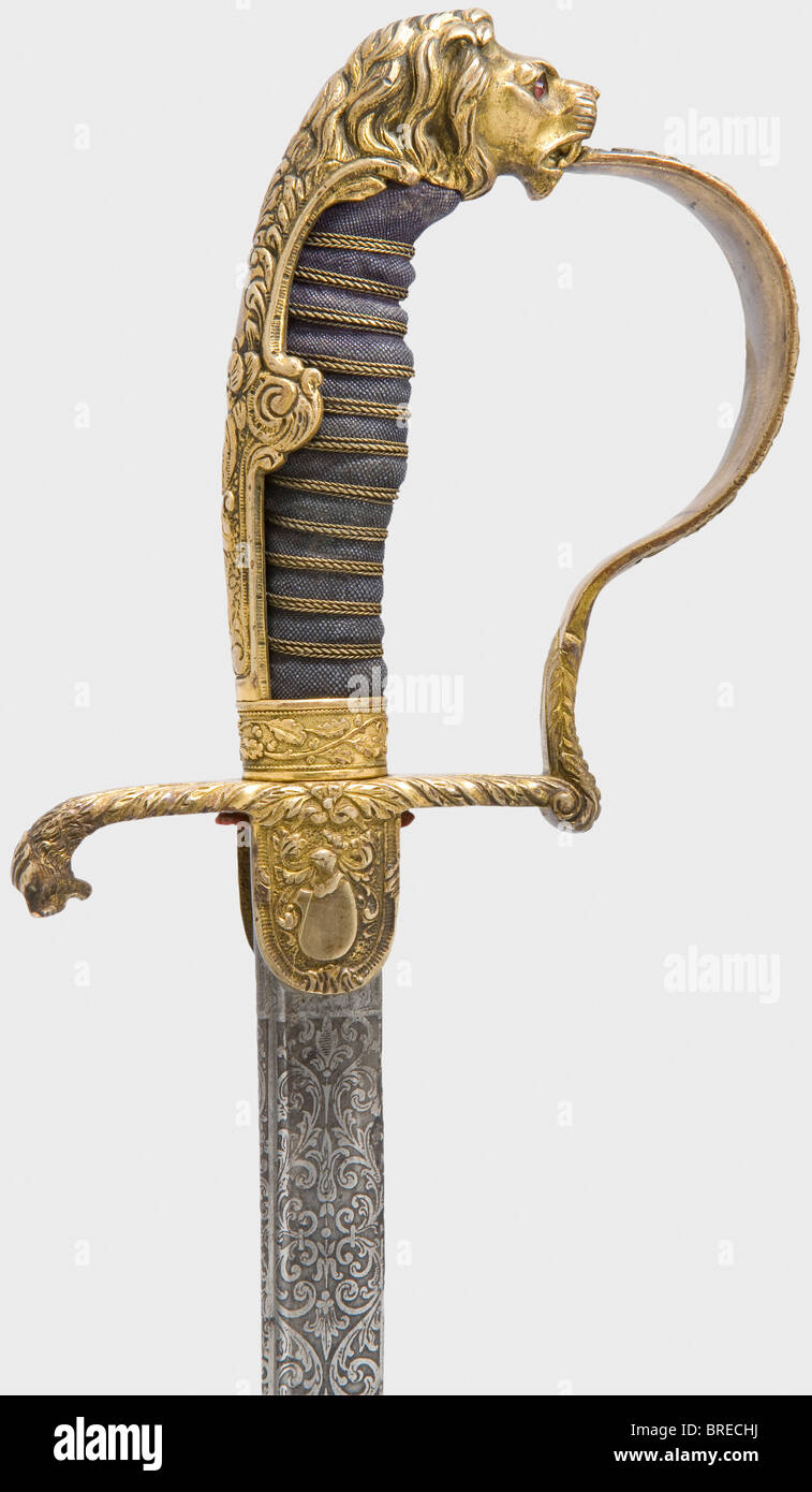 A presentation sabre with a Damascus blade, to a Prussian artillery officer Curved pipe-backed blade of forged Damascus (sharpened, cleaned) with yelmen and decorative floral etching on the upper half along with the dedication, 'J.W. Colsman s/l R. Bäuerle - 1910' with a student fraternity logo, and the maker's mark 'WKC'. Gold-plated knuckle-bow hilt with a lion head grip cap (with red glass eyes) and abundant floral decoration in relief. The obverse languet bears crossed cannon barrels. Black sharkskin grip cover with wire winding. Black lacquered steel scabb, Stock Photo