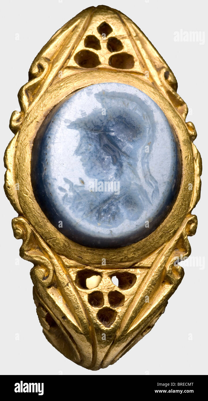 A Roman gold ring with an agate gem, 3rd/4th century A.D. Heavy band with richly engraved openwork decoration. A blue, layered agate set in the top, carved with the head of Minerva. Cleaned excavation discovery. Weight 34 g. historic, historical, ancient world, ancient world, ancient times, object, objects, stills, clipping, cut out, cut-out, cut-outs, jewellery, jewelry, noble, precious, Stock Photo