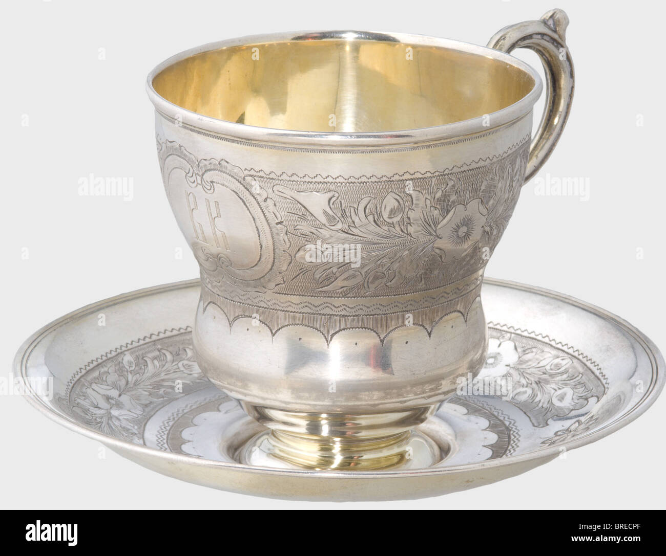 A silver tea cup and saucer, Moscow, 1867. Silver, gilt in places and with delicate floral engraving. The cup displays the monogram 'V.K.' in front. Each piece bears the master's mark, 'NA', the Moscow hallmark for '84' zolotniki, the inspecting master's mark 'BC', and the year '1867' on the bottom. Height of the cup 8.5 cm. Diameter of the saucer 13.5 cm. Total weight 199 g. Provenance: Grand Duchess Vera Konstantinovna Romanova (1854 - 1912). historic, historical, 19th century, dish, dishes, cup, cups, object, objects, stills, clipping, clippings, cut out, cu, Stock Photo