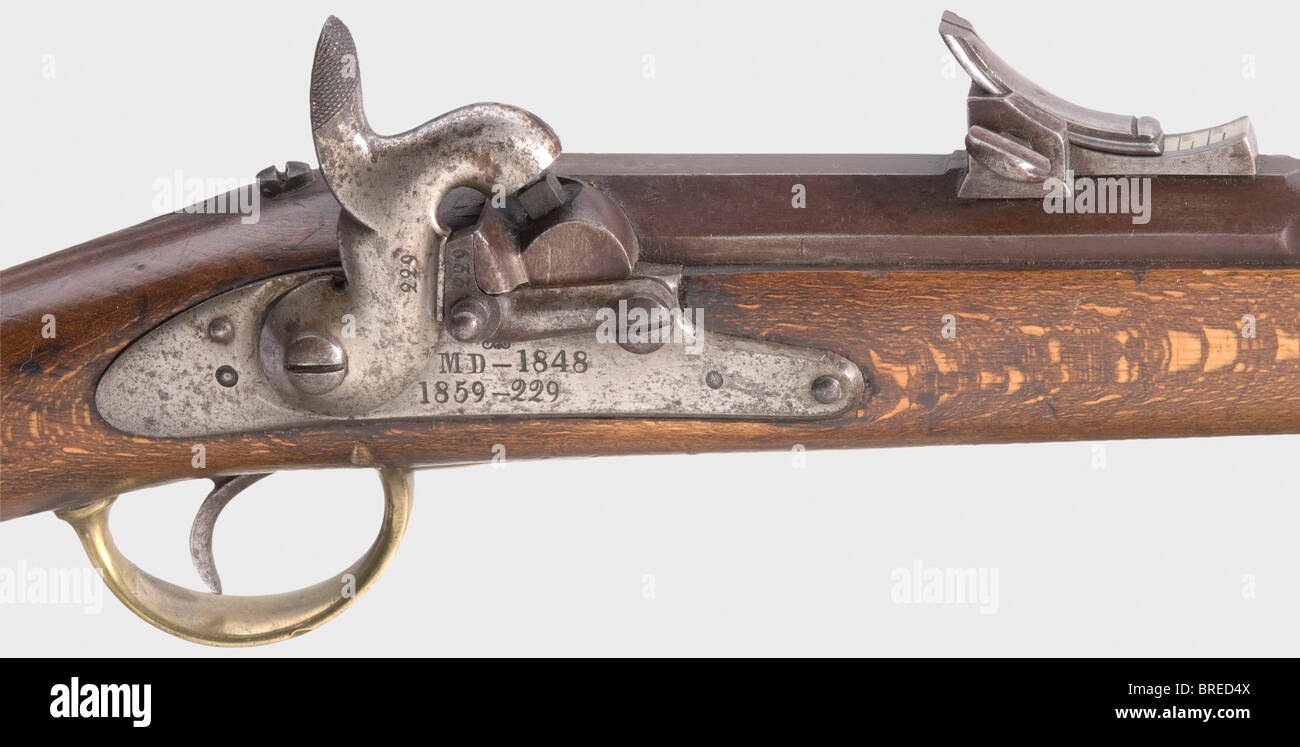 An infantry rifle M 1848, serial number 1859-229. Matching numbers. Two-stage barrel, octagonal breech section, then round, with rifled bore in 17 mm calibre with adjustable sights. Percussion lock with a safety catch, the model number and weapon number on the lock plate. Full stock with iron/brass furniture. Iron ramrod. Matching bayonet with matching number. Bluing rubbed. Iron parts somewhat stained . Stock retouched. Length 131 cm. Most of the model 1848 rifles were altered to the English Snider breech-loading system in 1865. historic, historical, 19th cent, Stock Photo