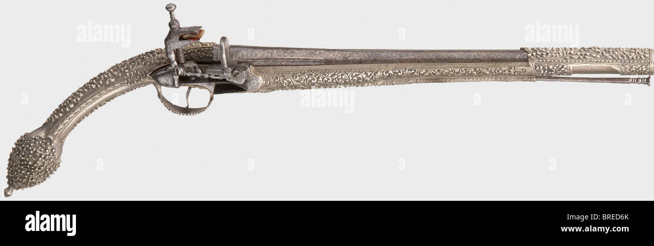 A Balkan-Turkish miquelet-lock pistol with a nickel-silver stock, 1st half of the 19th century Smooth bore barrel in 16 mm calibre with chiselled vine decoration on the breech, rubbed by cleaning. Cut and engraved miquelet-lock (frizzen defective) with the maker's mark. Nickel-silver stock, with lavish floral decoration, barrel sleeve decorated en suite, and with an iron ramrod. Length 52 cm. historic, historical, 19th century, Ottoman Empire, handgun, handheld, firearm, fire arm, gun, fire arms, firearms, guns, weapon, arms, weapons, arms, pistols, object, obj, Stock Photo