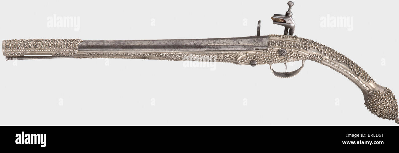 A Balkan-Turkish miquelet-lock pistol with a nickel-silver stock, 1st half of the 19th century Smooth bore barrel in 16 mm calibre with chiselled vine decoration on the breech, rubbed by cleaning. Cut and engraved miquelet-lock (frizzen defective) with the maker's mark. Nickel-silver stock, with lavish floral decoration, barrel sleeve decorated en suite, and with an iron ramrod. Length 52 cm. historic, historical, 19th century, Ottoman Empire, handgun, handheld, firearm, fire arm, gun, fire arms, firearms, guns, weapon, arms, weapons, arms, pistols, object, obj, Stock Photo