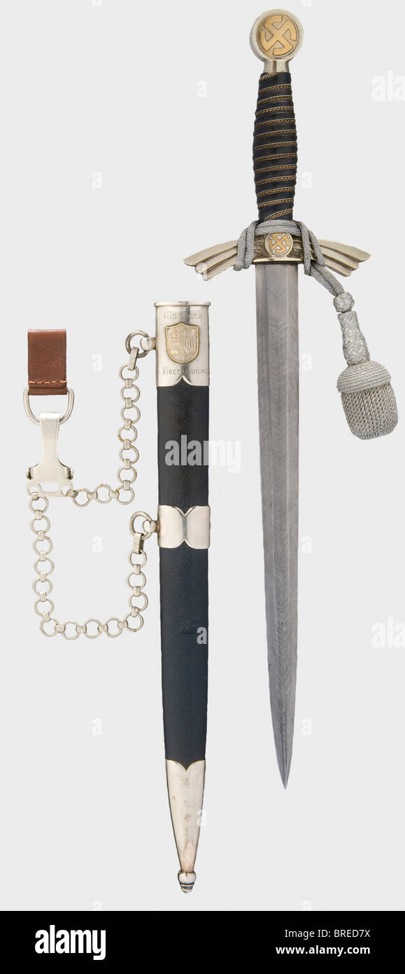 A model 1935 pilot's dagger, a presentation dagger with Damascus blade First version of nickel silver. The blade is of genuine Turkish Damascus steel. Nickel silver hilt, quillons, and locket marked with a '10'. The sun wheels gilt. The grip winding runs to the left. Leather-covered iron scabbard, nickel silver mountings, and suspension chain. A dedication engraving on the inner side of the locket, 'Als Dank u. Anerkennung' (In Thanks and Recognition) as well as a soldered, stamped coat of arms for Nordfriesland. Length 45 cm. Simple dagger with an unusual blad, Stock Photo