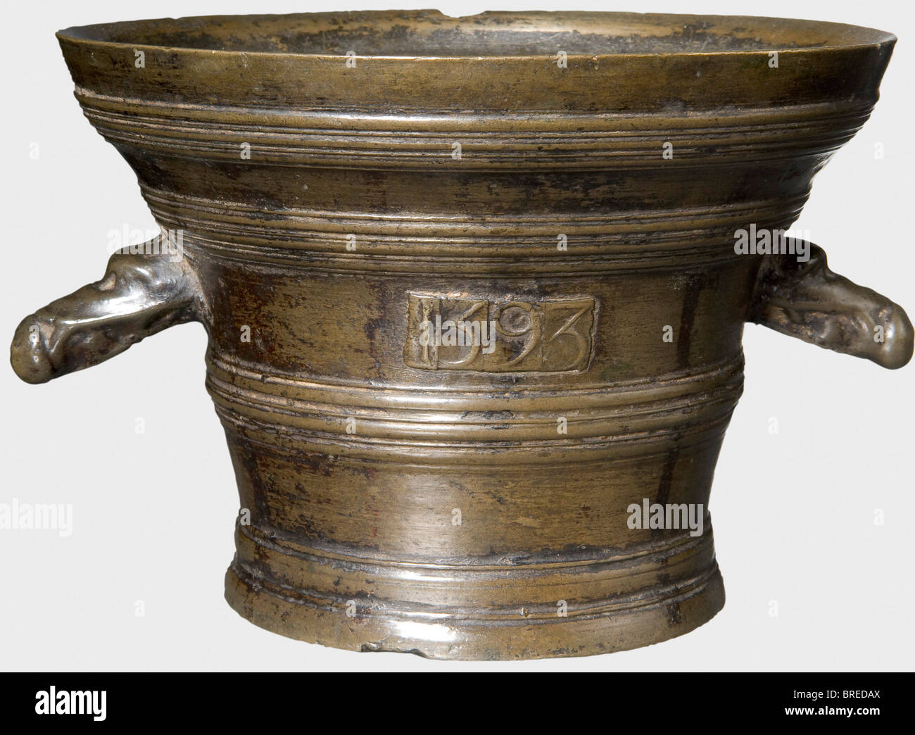 An Italian bronze mortar, dated 1593 Bronze with beautiful old patina. Conical body with strongly flared lip and a small pedestal. The exterior with banded sections, on the viewing surface applied '1593'. Two lateral dragon-headed handles. The lip has some small nicks. Height 12 cm, diameter 17.5 cm. historic, historical, 16th century, handicrafts, handcraft, craft, object, objects, stills, clipping, clippings, cut out, cut-out, cut-outs, vessel, vessels, Stock Photo