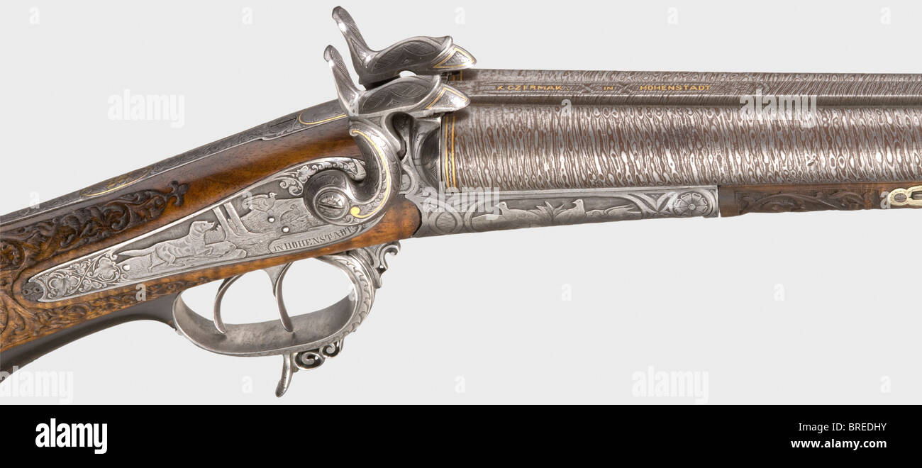 A pin-fire side-by-side shotgun, K. Czermak in Hohenstadt circa 1860. Damascus barrels with somewhat rough bores in 17 mm calibre, a gold-inlaid signature on the mid rib. Back action locks, lock plates signed as well. Finely craved walnut stock with iron furniture richly engraved with hunting scenes inlaid in gold. Trigger guard partly made of horn. Length 116 cm. Erwerbsscheinpflichtig. historic, historical, 19th century, civil long guns, gun, weapons, arms, weapon, arm, firearm, fire arm, gun, fire arms, firearms, guns, object, objects, stills, clipping, clip, Stock Photo