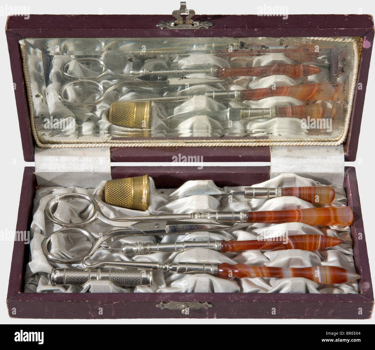 A traveller's sewing kit with agate handles., circa 1900 Seven pieces, four beautifully figured agate handles. In an artificial leather case with light blue silk lining, and a mirror (somewhat stained) in the lid. Inventory label, 'H.V.v.W. G.v.R. Privat-Eigentum' on the bottom. Dimensions ca. 16.5 x 8.5 x 2.8 cm. Provenance: Grand Duchess Vera Konstantinovna Romanova (1854 - 1912). historic, historical, 1900s, 20th century, 19th century, object, objects, stills, clipping, clippings, cut out, cut-out, cut-outs, fine arts, art, artful, Stock Photo