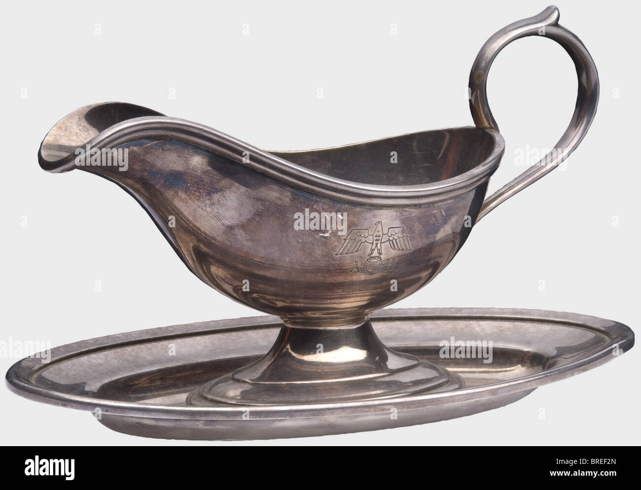 Adolf Hitler, a sauce boat from his personal table silver Hard silver plating, one-piece version (screwed together) with a national eagle engraved on one side above the letters 'AH'. Marked, 'Wellner - 30 cl - 25' on the bottom. Width ca. 24 cm. Height ca. 14 cm. historic, historical, 1930s, 1930s, 20th century, NS, National Socialism, Nazism, Third Reich, German Reich, Germany, German, National Socialist, Nazi, Nazi period, fascism, vessel, vessels, object, objects, stills, clipping, clippings, cut out, cut-out, cut-outs, Stock Photo