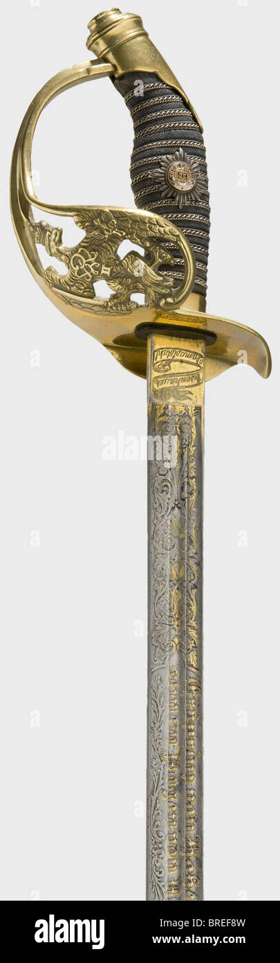Hereditary Prince Wilhelm August v. Hohenzollern, an infantry officer's sword model 1889 with presentation inscription Damascus steel blade with two narrow fullers, and etched and gilt floral decoration with the inscription 'Für treue Pagendienste im Jahre 1904 - Erbprinz von Hohenzollern seinem Pagen von Niebelschütz'. Etched on the ricasso 'Eisenhauer Damaststahl', on the reverse the maker's mark 'A. Werth Solingen'. Tombac hilt with the Prussian eagle, rayskin grip cover with applied silver guard star with enamelled centre. Gilding on blade present only in a, Stock Photo