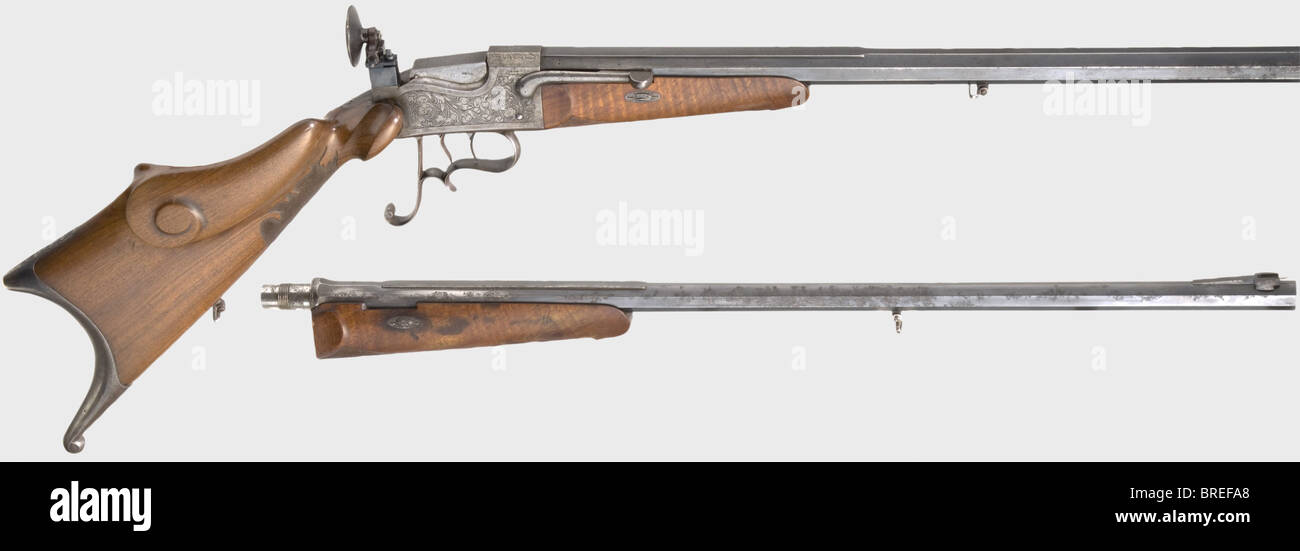 A gallery rifle Büchel system, German, circa 1880. Heavy octagonal barrel with insert barrel in calibre 4 mm, barrel length 65.5 cm. Receiver with vine engraving, on upper surface patent inscription. Set trigger, ring and bead sight. Walnut cripple stock. Length 111 cm. Additional rifled spare bore in calibre 9 mm, length 77 cm. Usage marks, spare barrel partially pitty. Erwerbsscheinpflichtig. historic, historical, 19th century, civil long guns, gun, weapons, arms, weapon, arm, firearm, fire arm, gun, fire arms, firearms, guns, object, objects, stills, clippin, Stock Photo