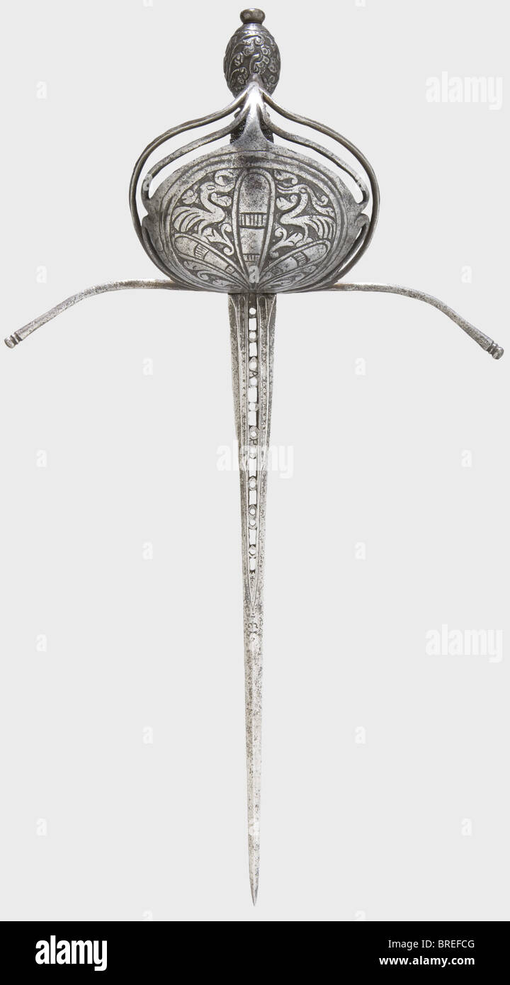 A left-hand dagger, Italy or Spain, circa 1660/70 Slender, ridged thrusting blade, the upper half with a perforated central fuller, the base widened and with triple fullers. The fullers bear stamped crosses and 'AP - ET'. Long, expansive quillons, the shell-like hand-guard with chiselled decoration. Grip with iron wire winding and Turk's heads. Olive-shaped pommel richly cut with tendril decoration. Length 46.5 cm. historic, historical,, 17th century, dagger, daggers, thrusting, thrustings, baton, weapon, arms, weapons, arms, fighting device, object, objects, s, Stock Photo