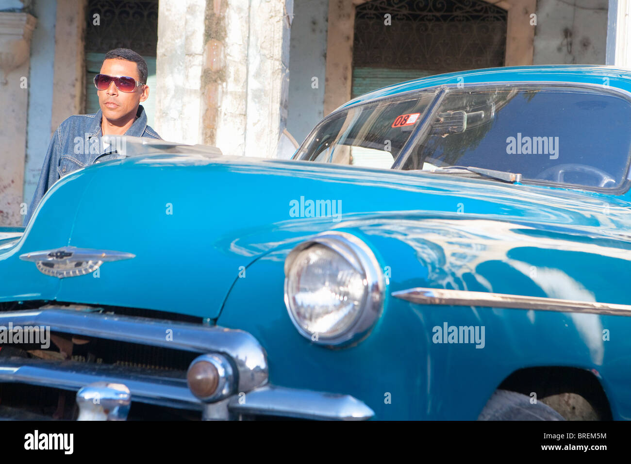 HABANA VIEJA: MAN STOOD WITH CLASSIC AMERICAN CAR Stock Photo