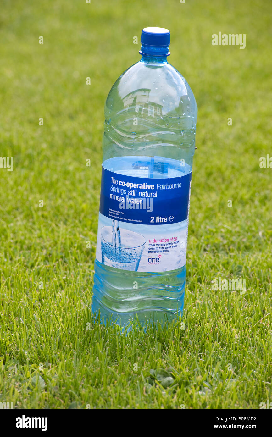 Half empty plastic mineral water bottle on a green lawn Stock Photo Alamy