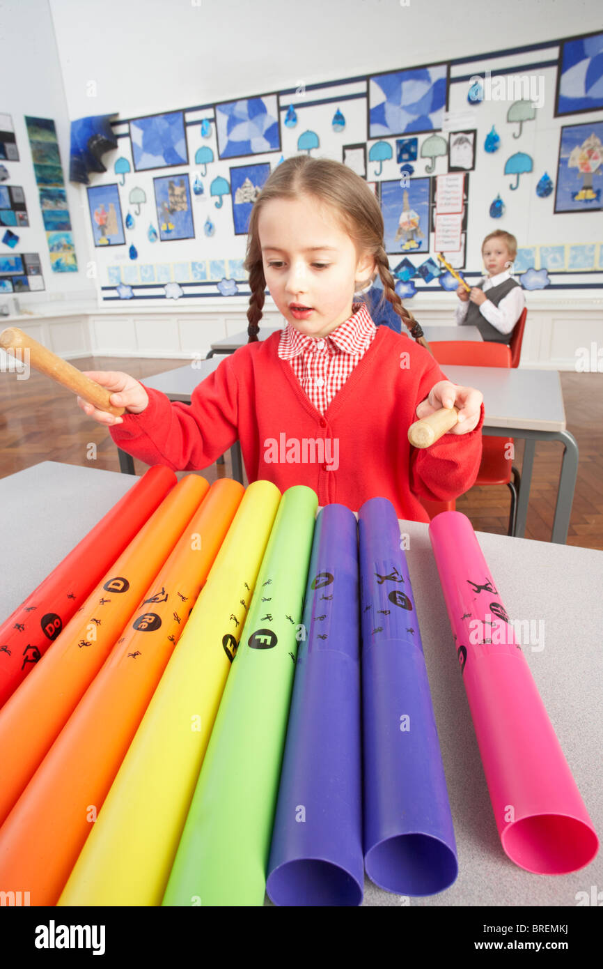 Group Of Primary Schoolchildren Having Music Lesson In Classroom Stock