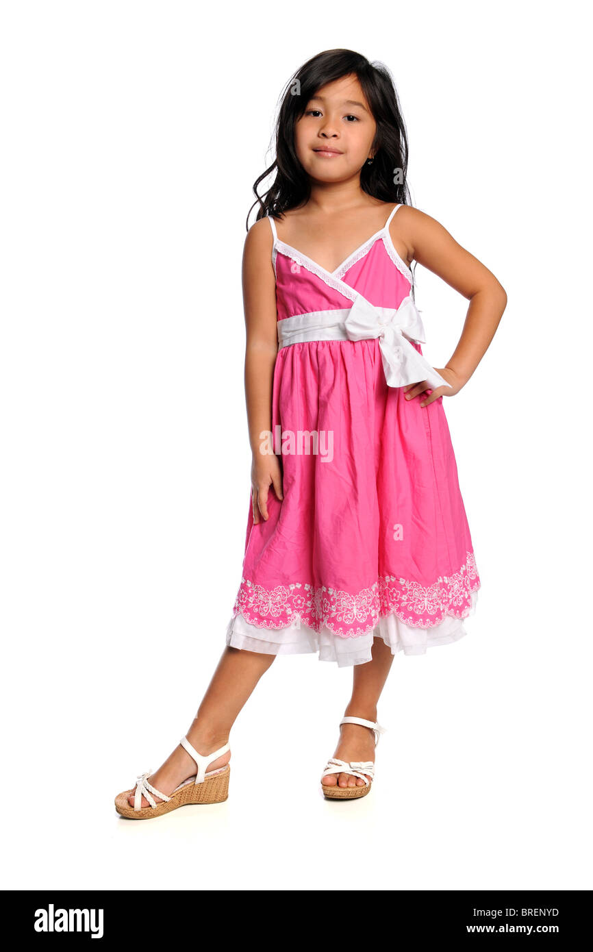 Young Asian girl in pink dress isolated over white background Stock Photo