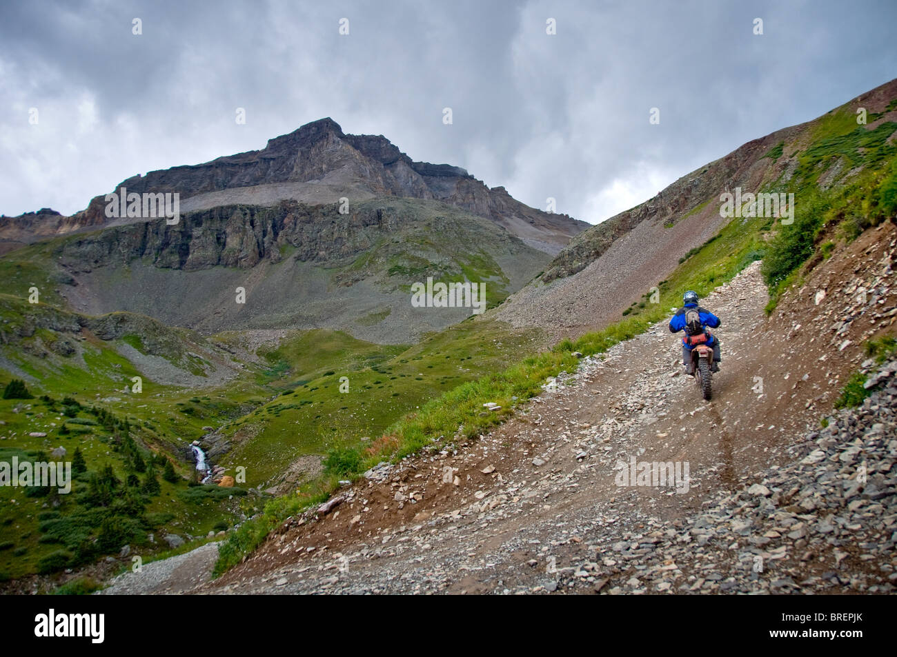 Motorcycle rider approaching Mount Sneffels, Yankee Boy Basin, Ouray, Telluride, Colorado. Stock Photo