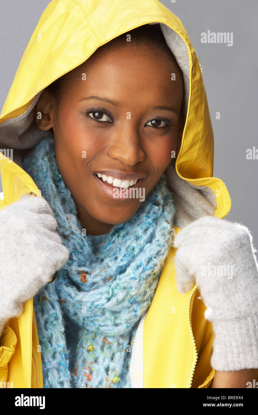 Young woman wearing yellow raincoat hi-res stock photography and images ...
