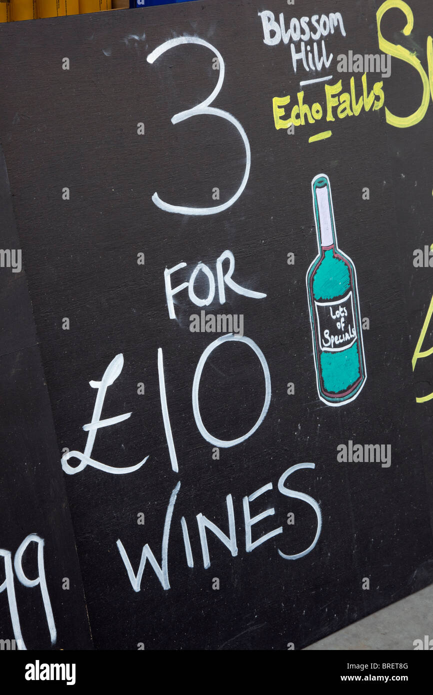 Boards advertising cheap wines outside an off license shop. UK, Britain Stock Photo