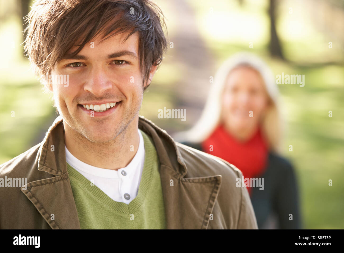 Portrait Of Romantic Young Couple In Autumn Park Stock Photo - Alamy