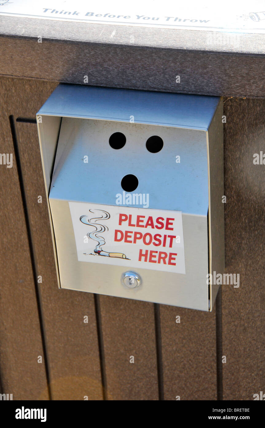 Container for cigarette disposal outside public building Stock Photo
