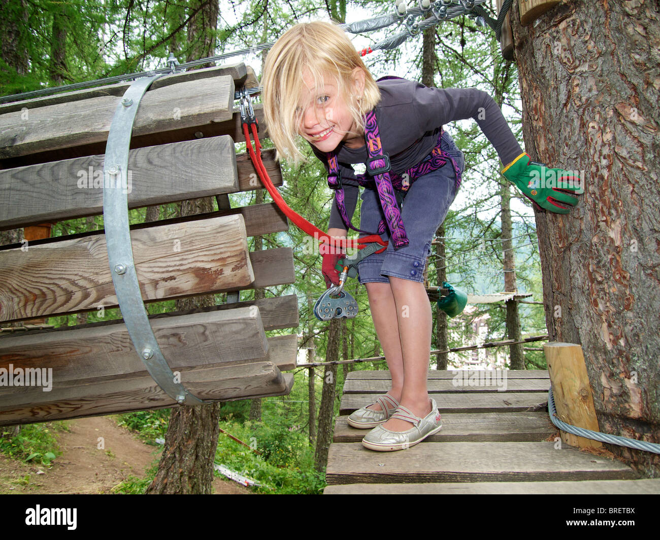 Little girl six years old playing in climbing mountaineering park in les Orres, Hautes Alpes, France Stock Photo