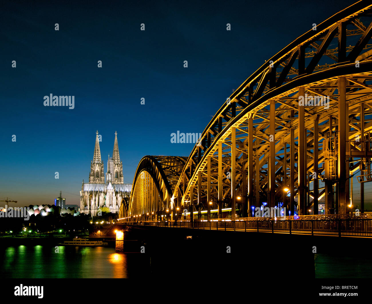 View on Cologne with railway bridge and Dom in the evening. Stock Photo