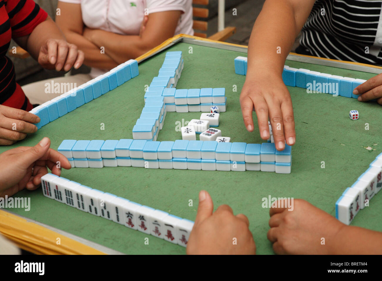 A Mahjong game in progress on a street in Shanghai, China. Stock Photo