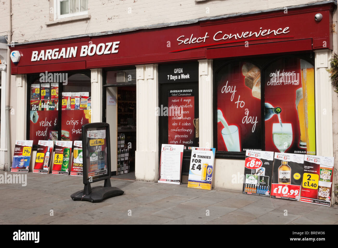 Bargain Booze shop front window with adverts for cheap alcohol. Wales