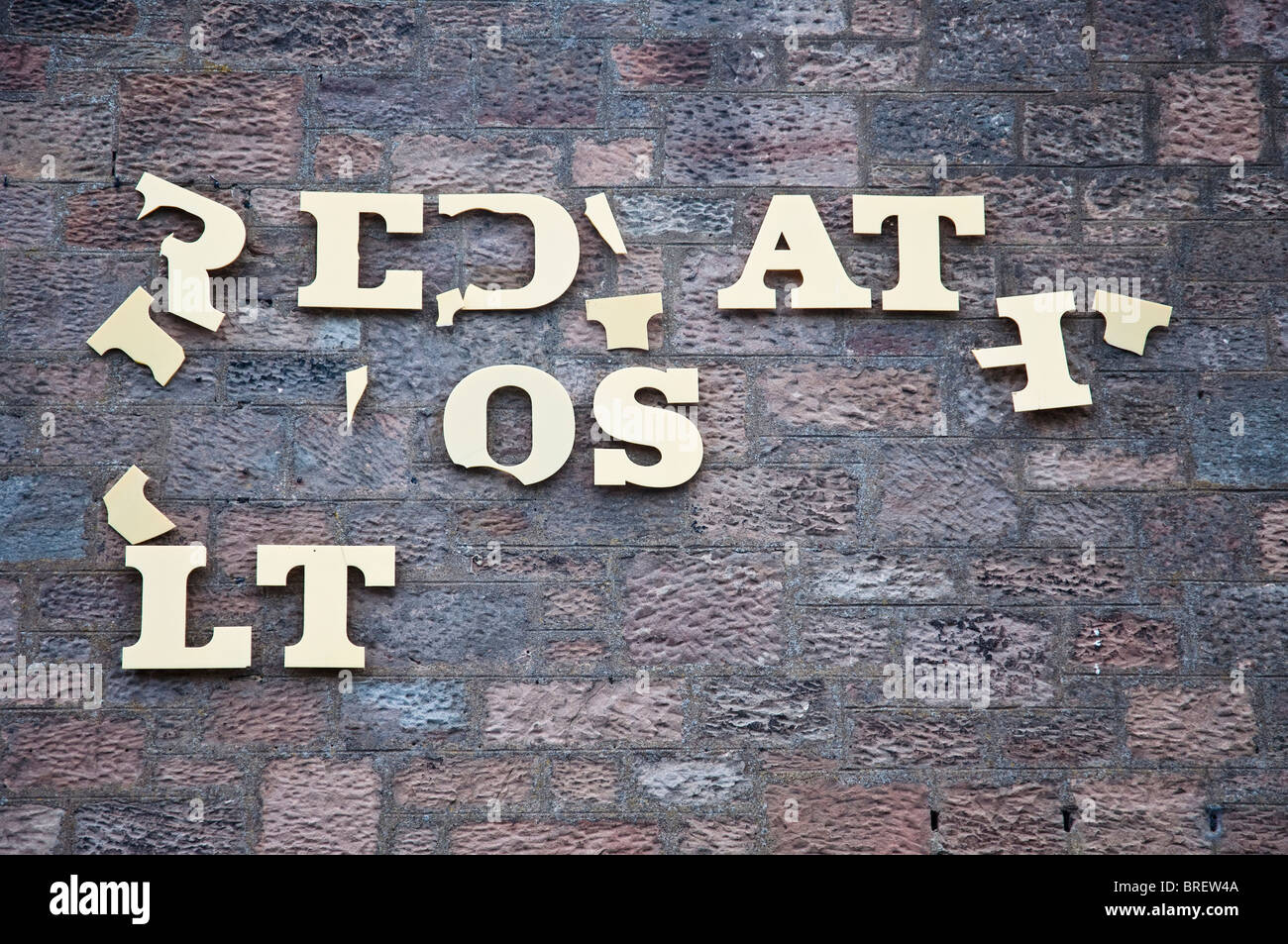 Broken sign on a building in Wooler, Northumberland. The letters have ...