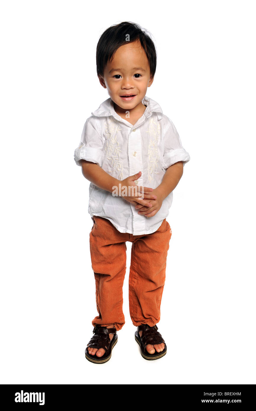 Portrait of young Asian boy standing over white background Stock Photo