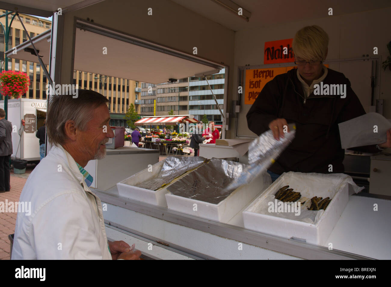 Senior man at stall selling lamperns (river lamprey) sold in autumn in Pori Finland Europe Stock Photo