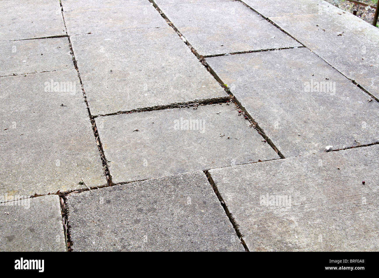 Uneven paving slabs representing a trip hazard Stock Photo Alamy
