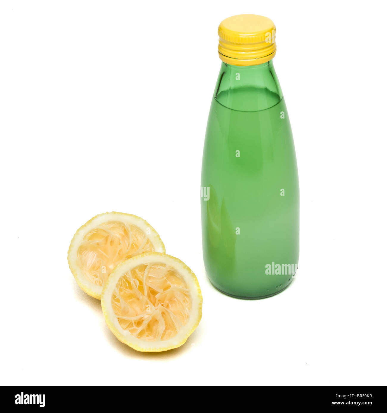freshly squeezed and bottled lemon juice concept isolated on white. Stock Photo