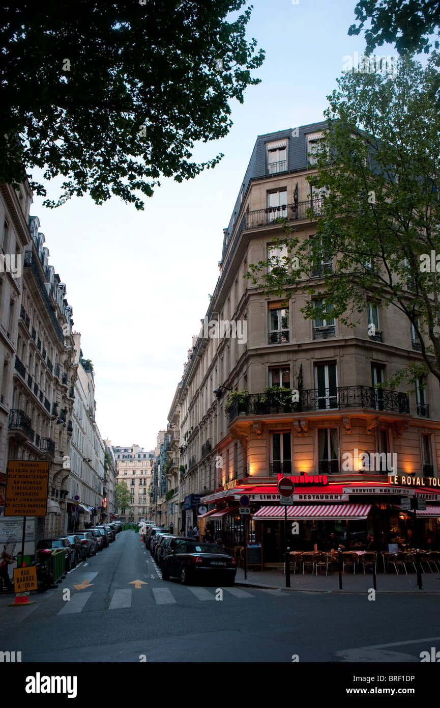 Parisienne cafe at dusk along a street in Paris, France Stock Photo